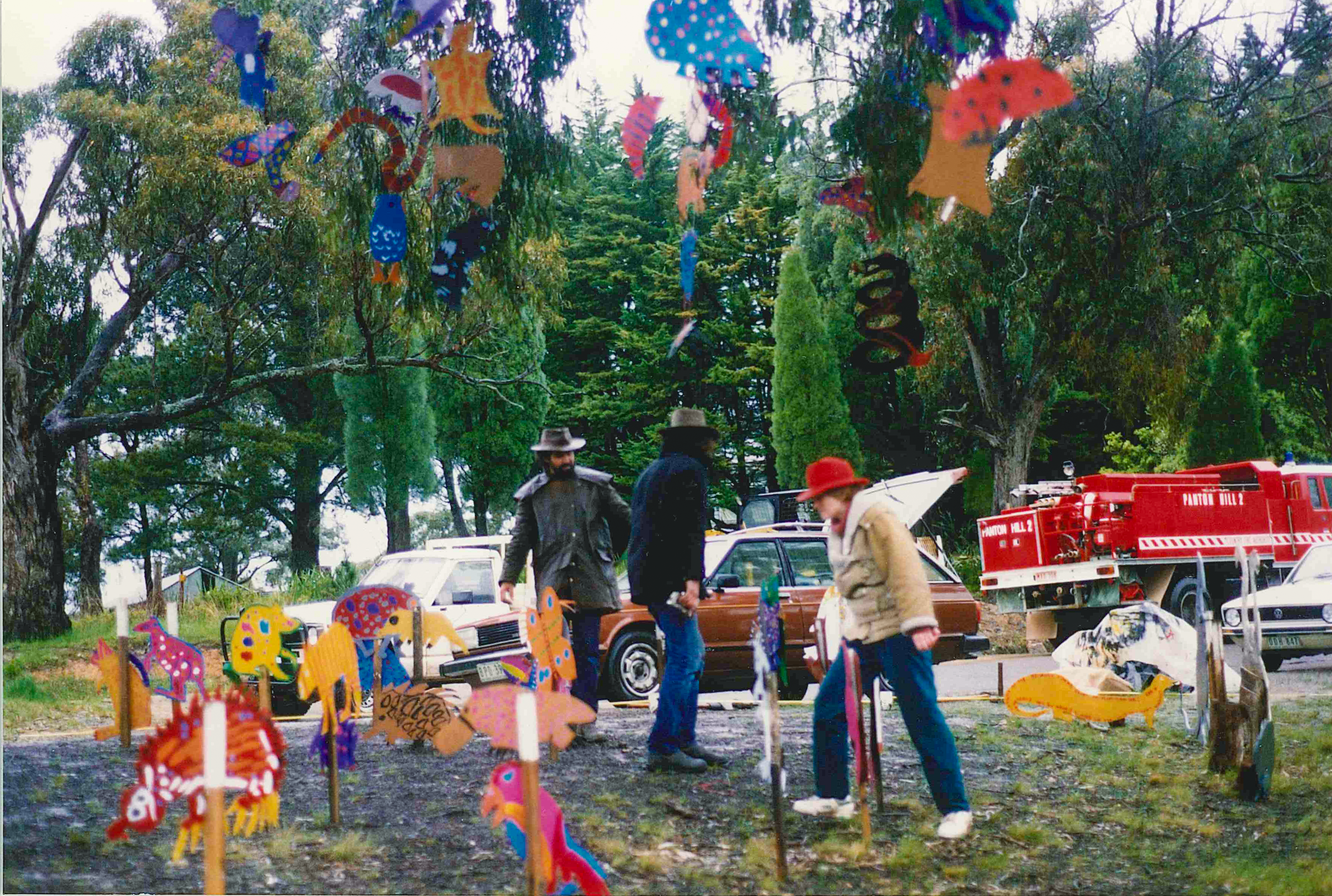 wooden animals are hanging from the trees