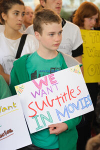 Boy holding sign.