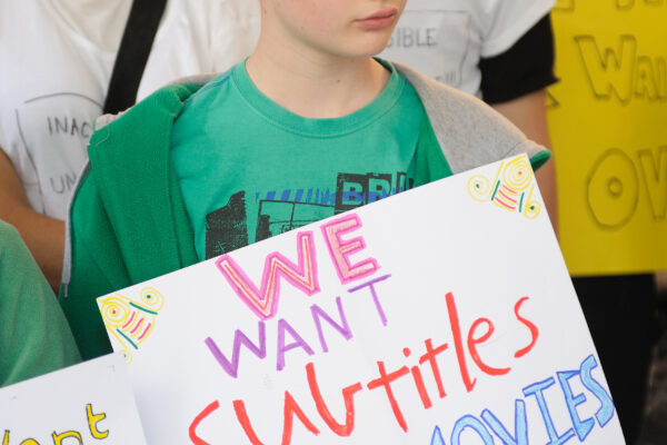 Boy holding sign.