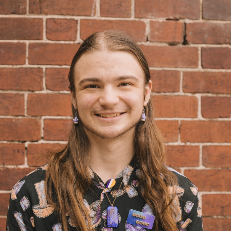 A Headshot of Keiran Speedy in front of a brick wall