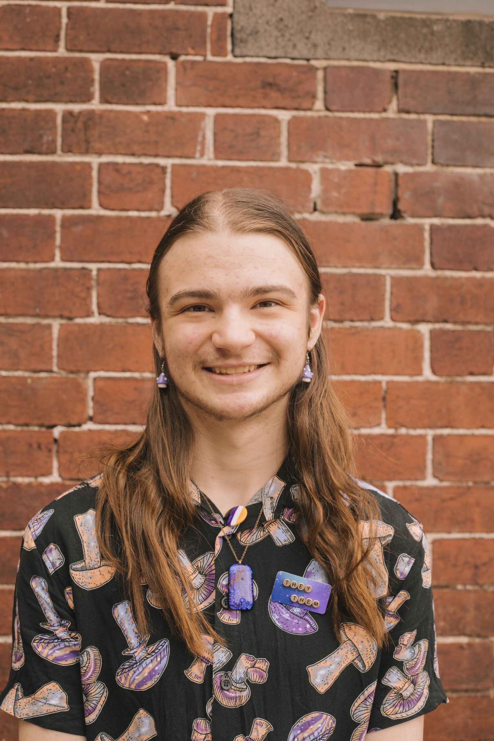 A Headshot of Keiran Speedy in front of a brick wall