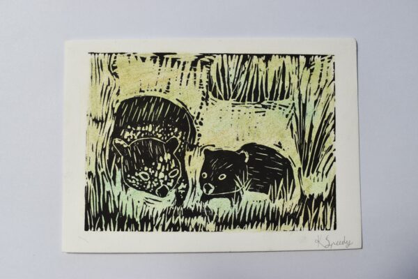 Linocut print of two wombats in grass on a green background