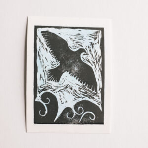 Linocut print of an eagle above clouds on a blue background