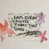 Linocut print in black ink of a text saying ‘I am every cracked thing that sings’. There is an orange watercolour flower on the left side of the frame and pink flowers on the right side.